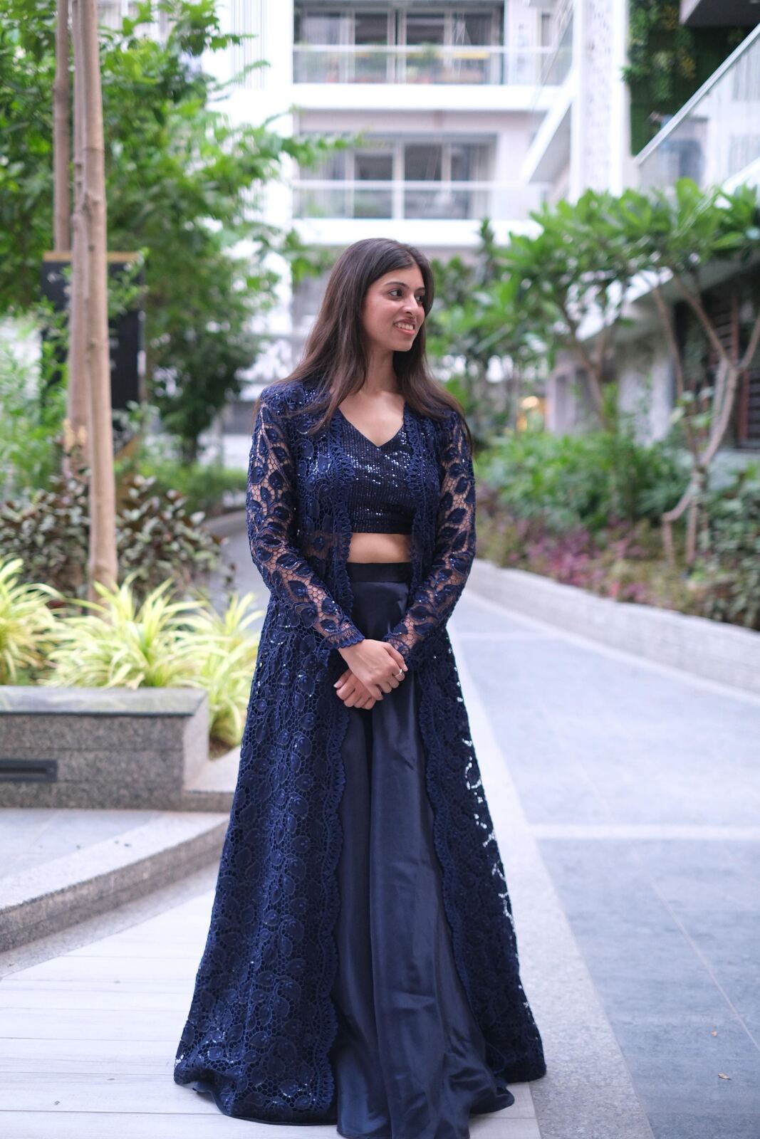 Navy lace jacket over sequin crop top and skirt
